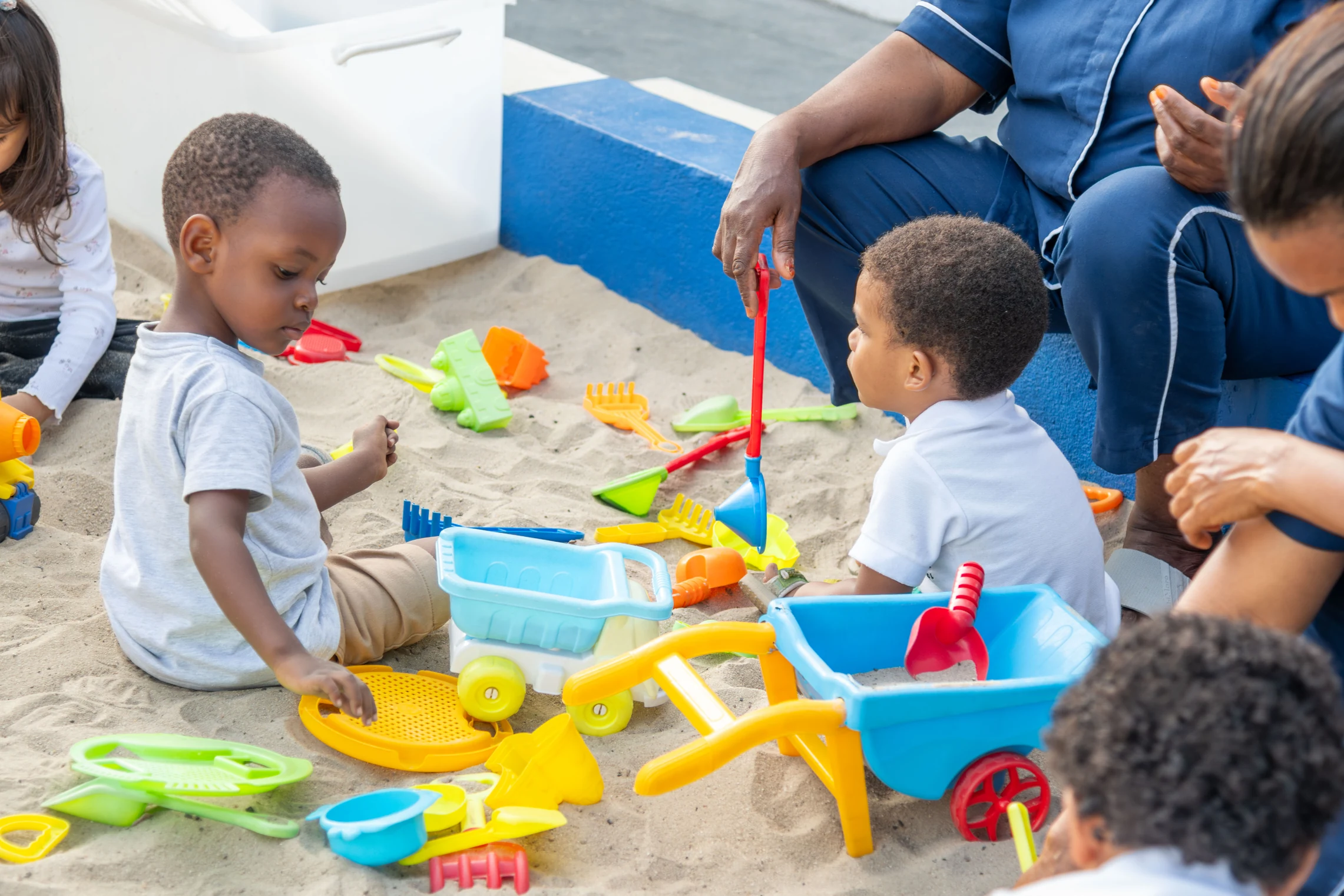 Children digging and building together in the sandpit